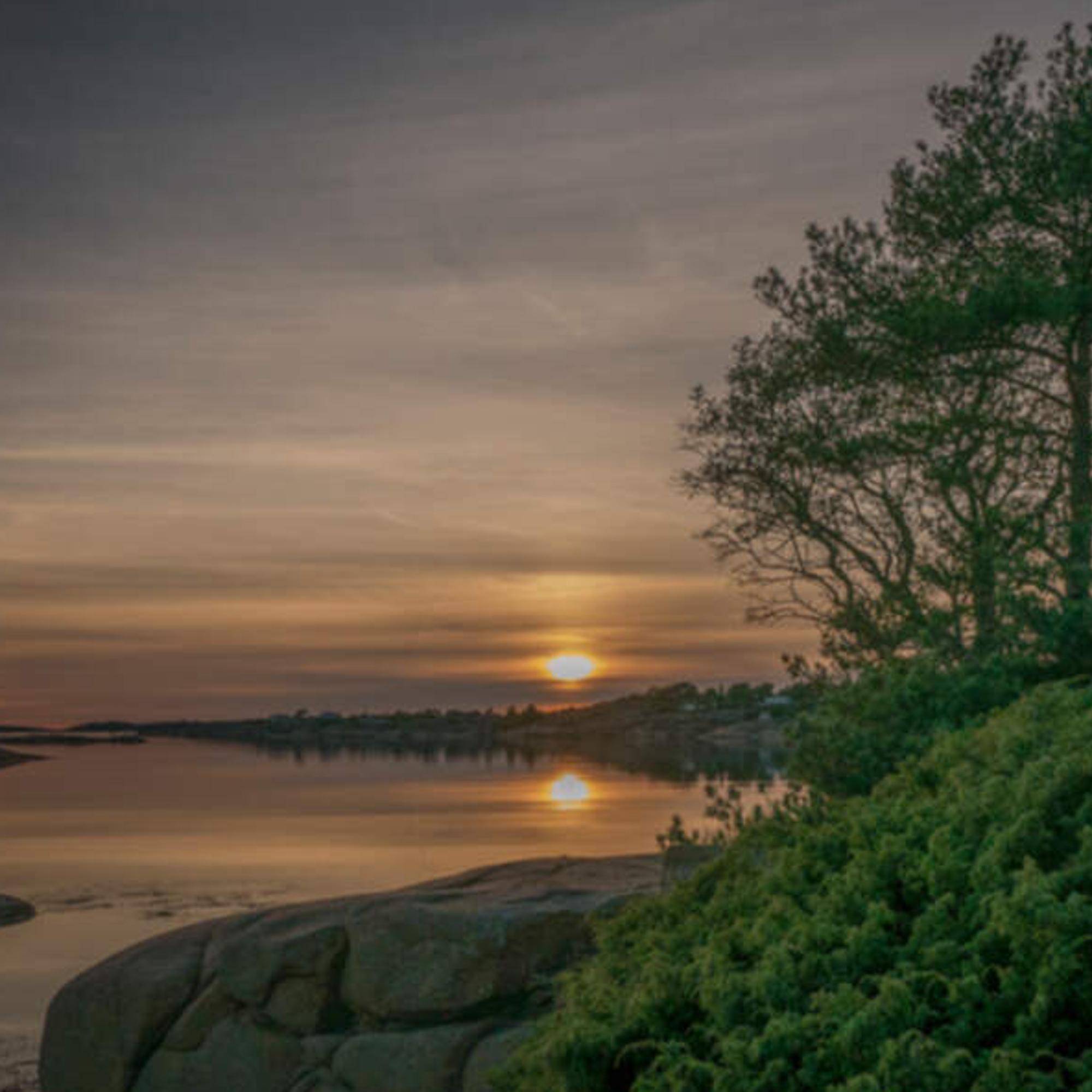 Solnedgången vid vattnet
