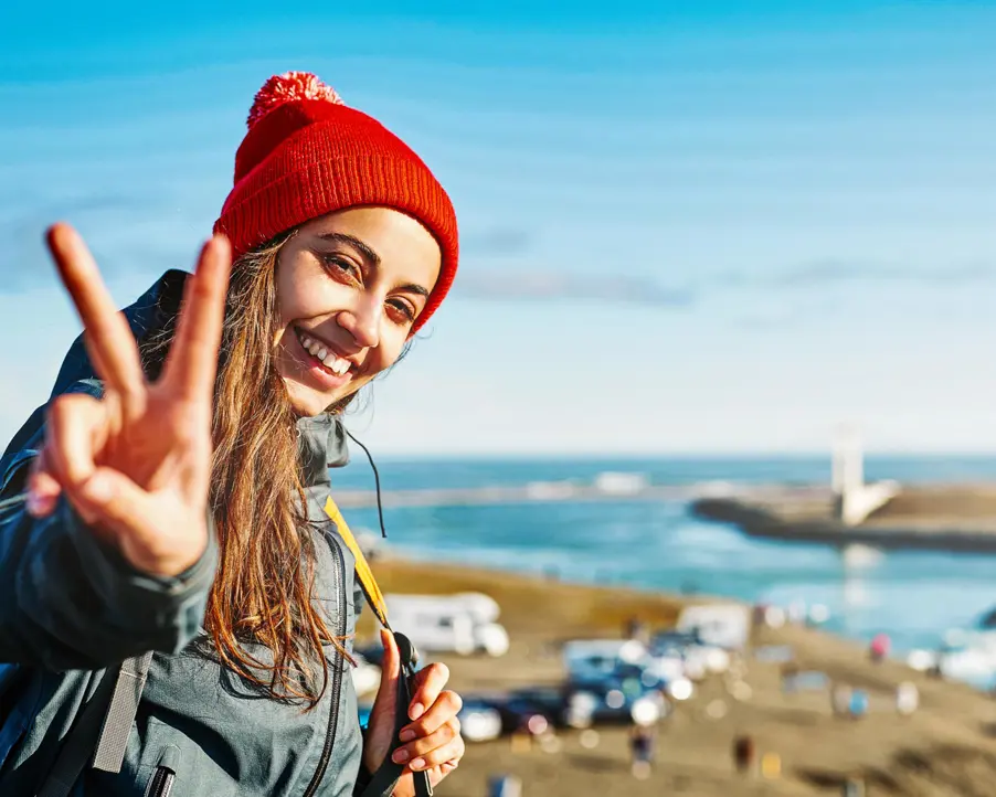 Kvinna gör V-tecken i solen