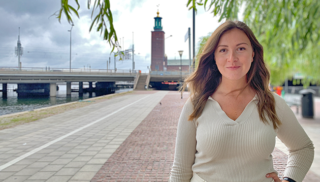 Kvinna vid strandpromenad nära Stockholms stadshus en molnig dag